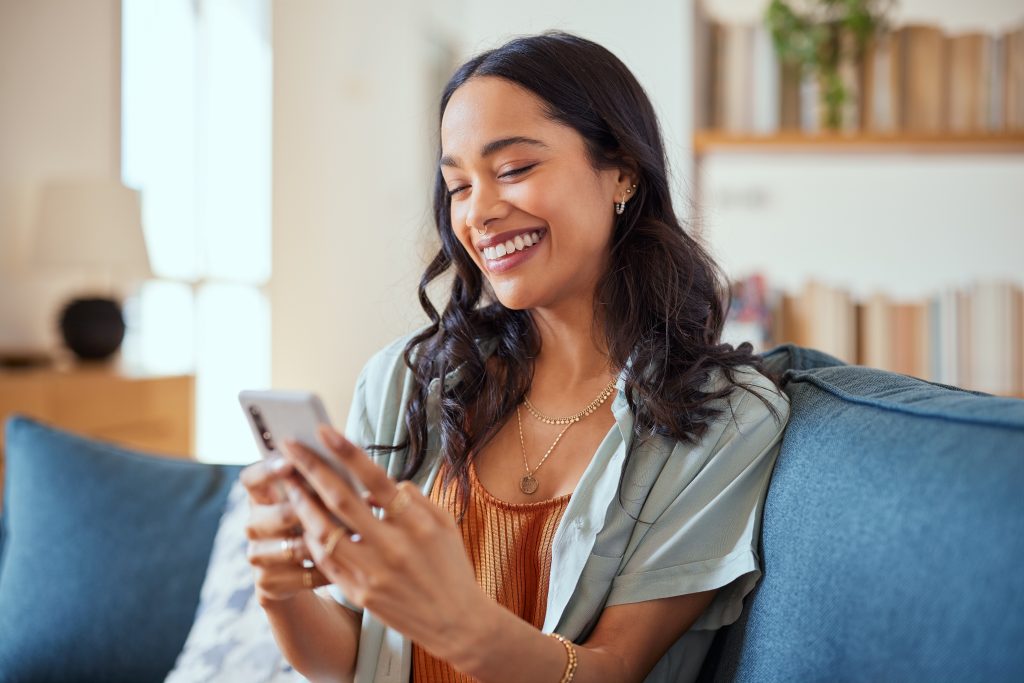 Cheerful woman setting up contactless pay with Pioneer Bank on her phone